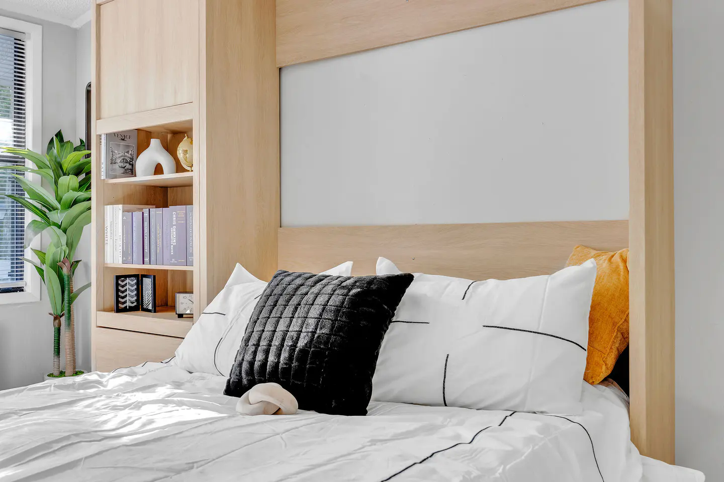 Apartment bedroom with built-in wood storage